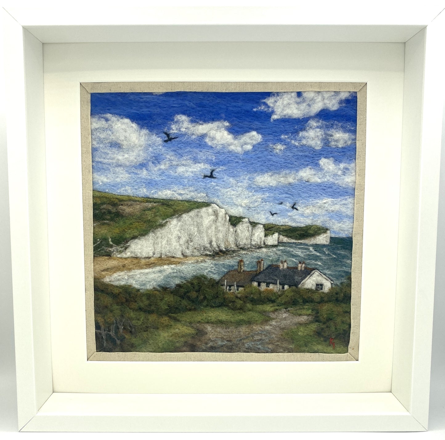 needle felted picture in a white wooden box frame, of a view of Cuckemere Haven and the Seven Sisters cliffs
