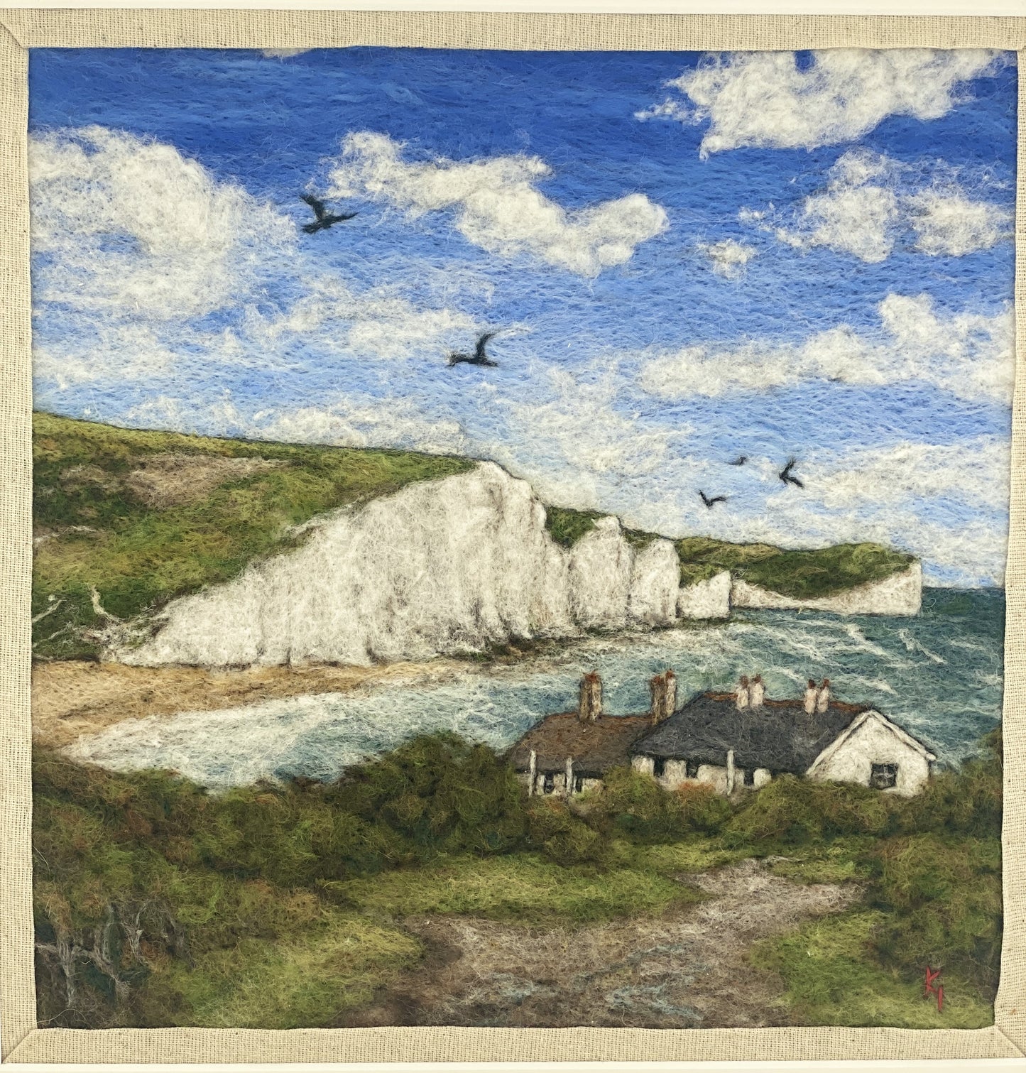 needle felted picture in a white wooden box frame, of a view of Cuckemere Haven and the Seven Sisters cliffs