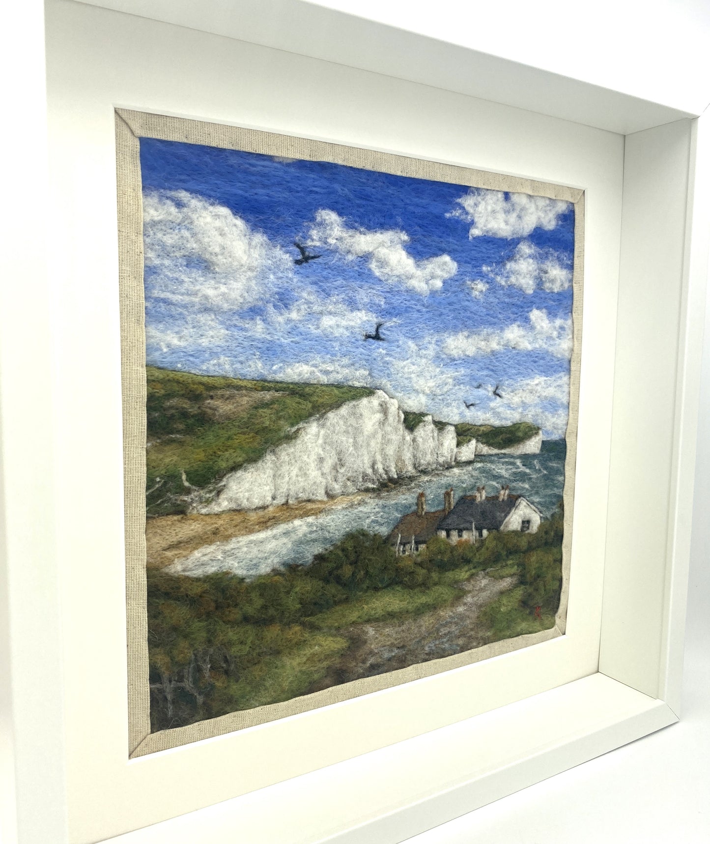 needle felted picture in a white wooden box frame, of a view of Cuckemere Haven and the Seven Sisters cliffs