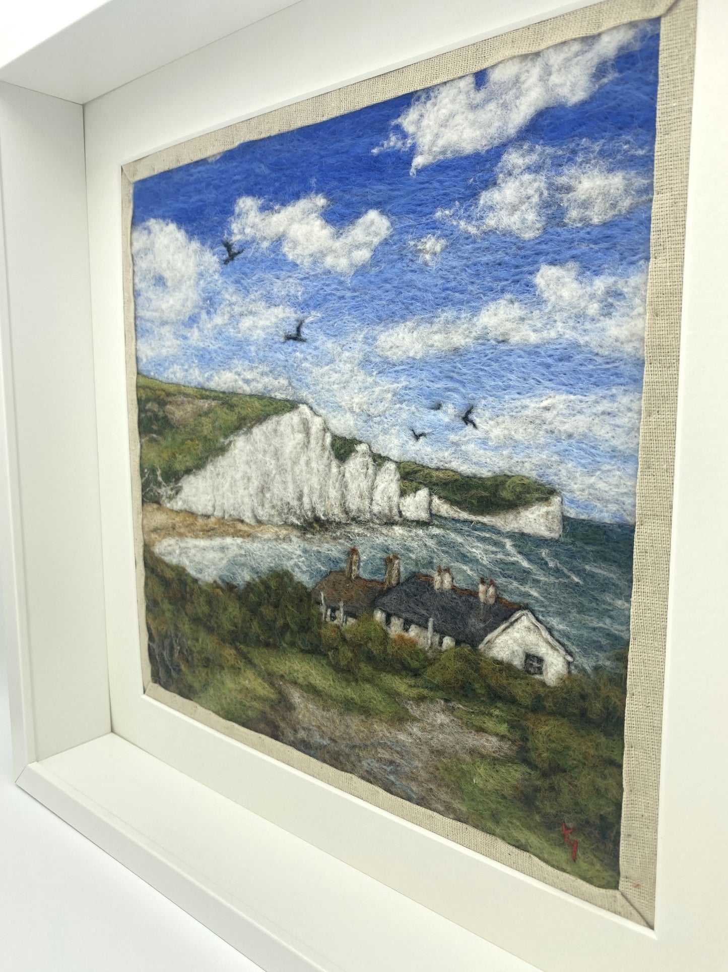 needle felted picture in a white wooden box frame, of a view of Cuckemere Haven and the Seven Sisters cliffs