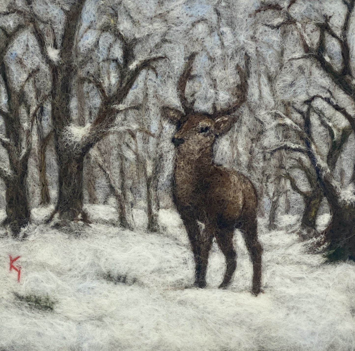 needle felted framed picture of a stag standing in woodland which is covered with fresh snow