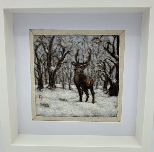 needle felted framed picture of a stag standing in woodland which is covered with fresh snow