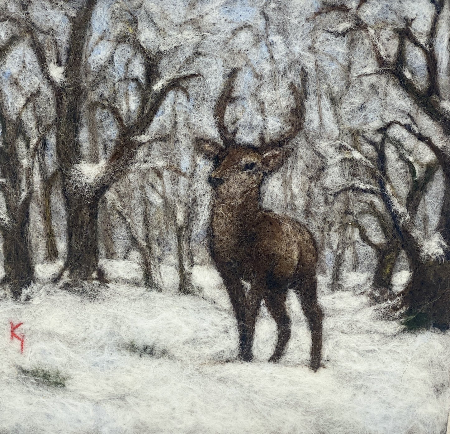 needle felted framed picture of a stag standing in woodland which is covered with fresh snow