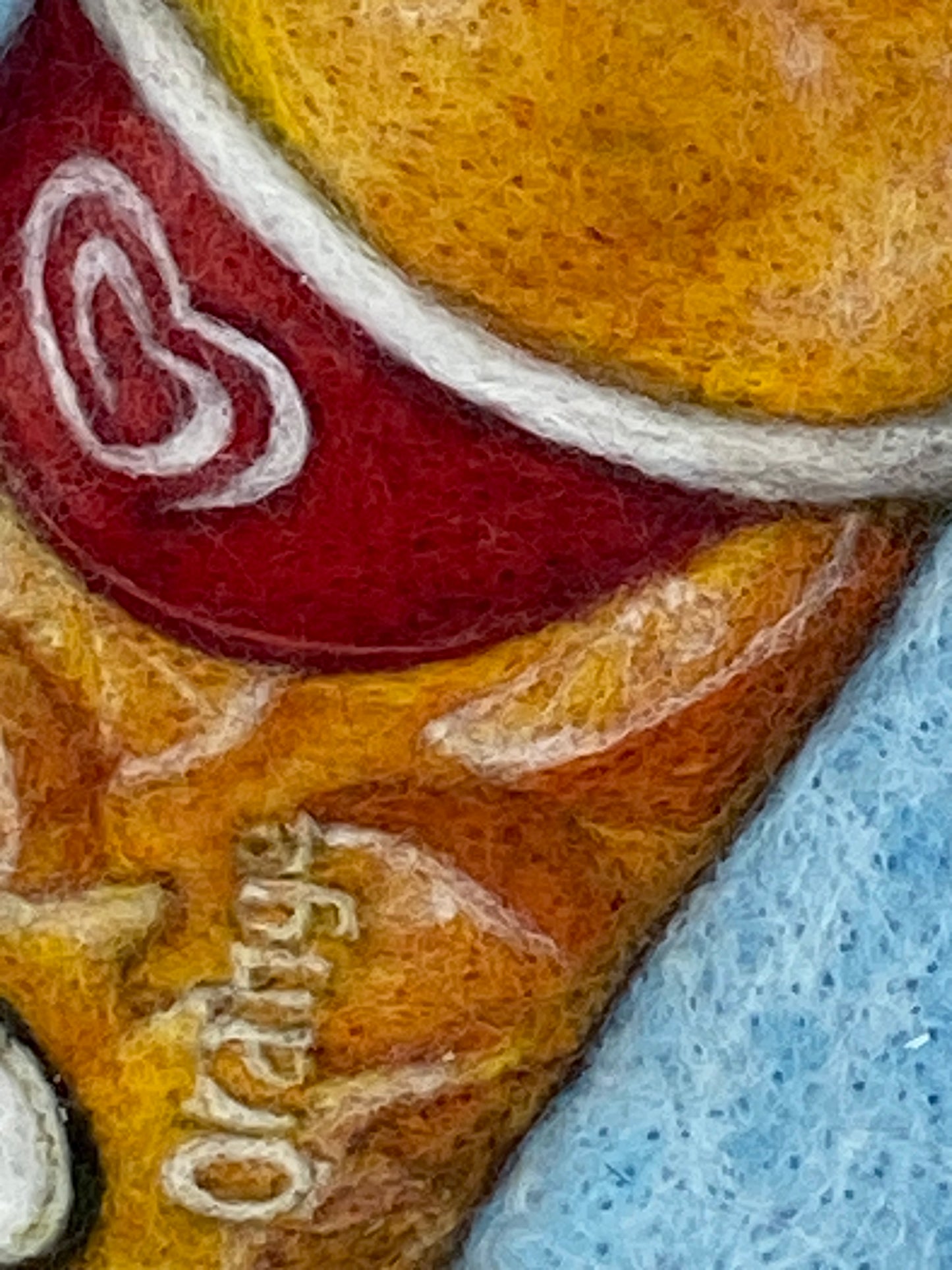 a white box framed needle felted study of an orange flavoured Calippo ice lolly on a blue background