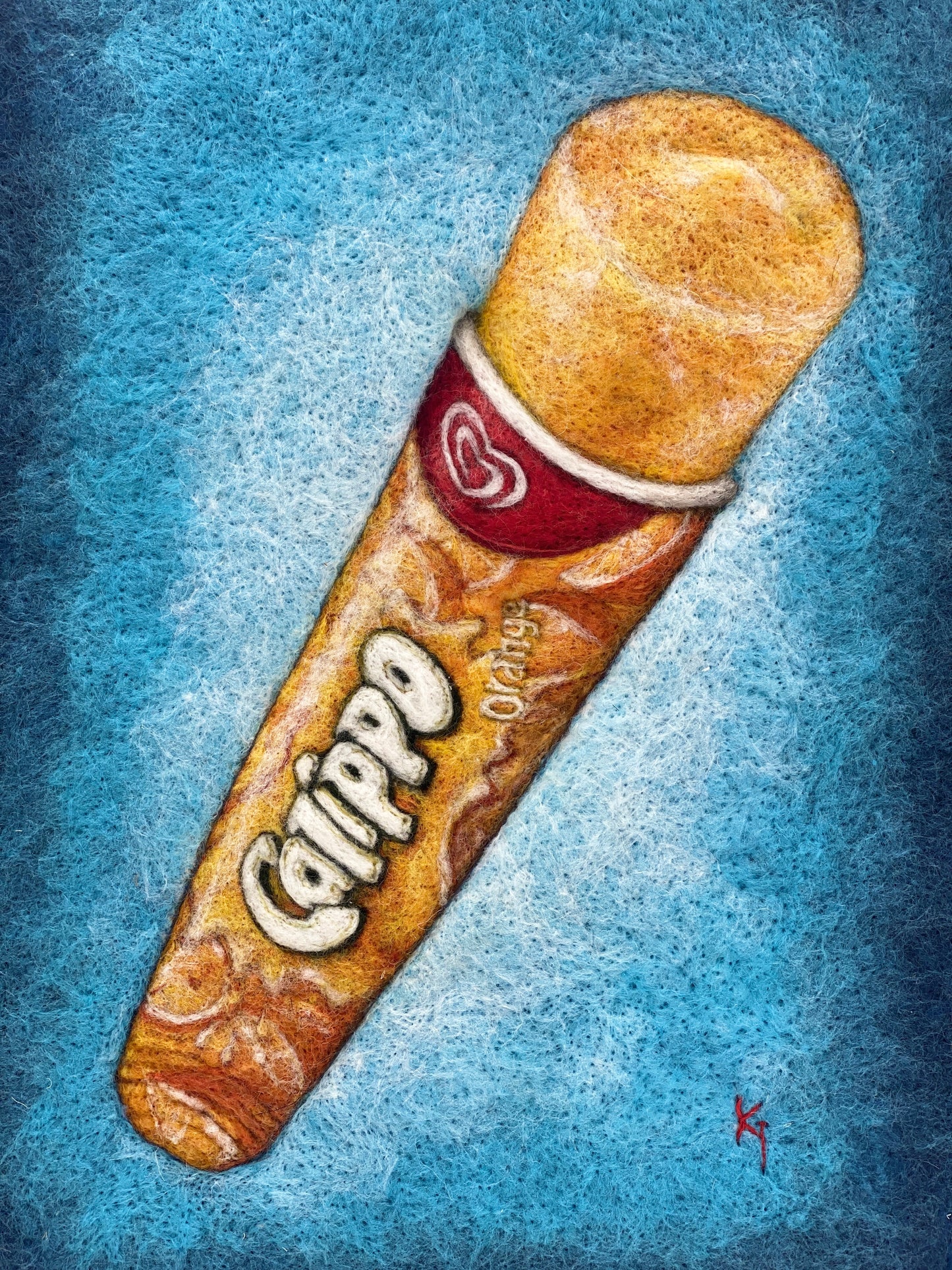a white box framed needle felted study of an orange flavoured Calippo ice lolly on a blue background
