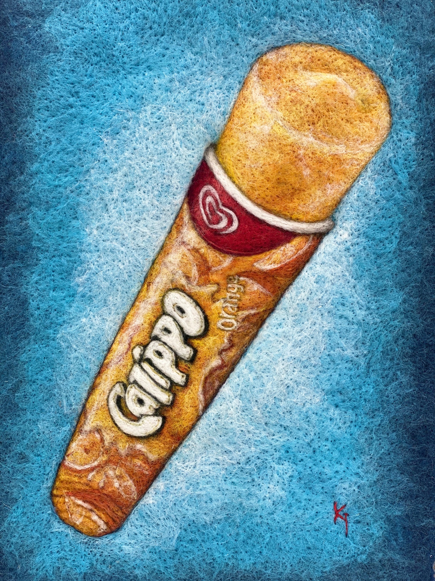 a white box framed needle felted study of an orange flavoured Calippo ice lolly on a blue background
