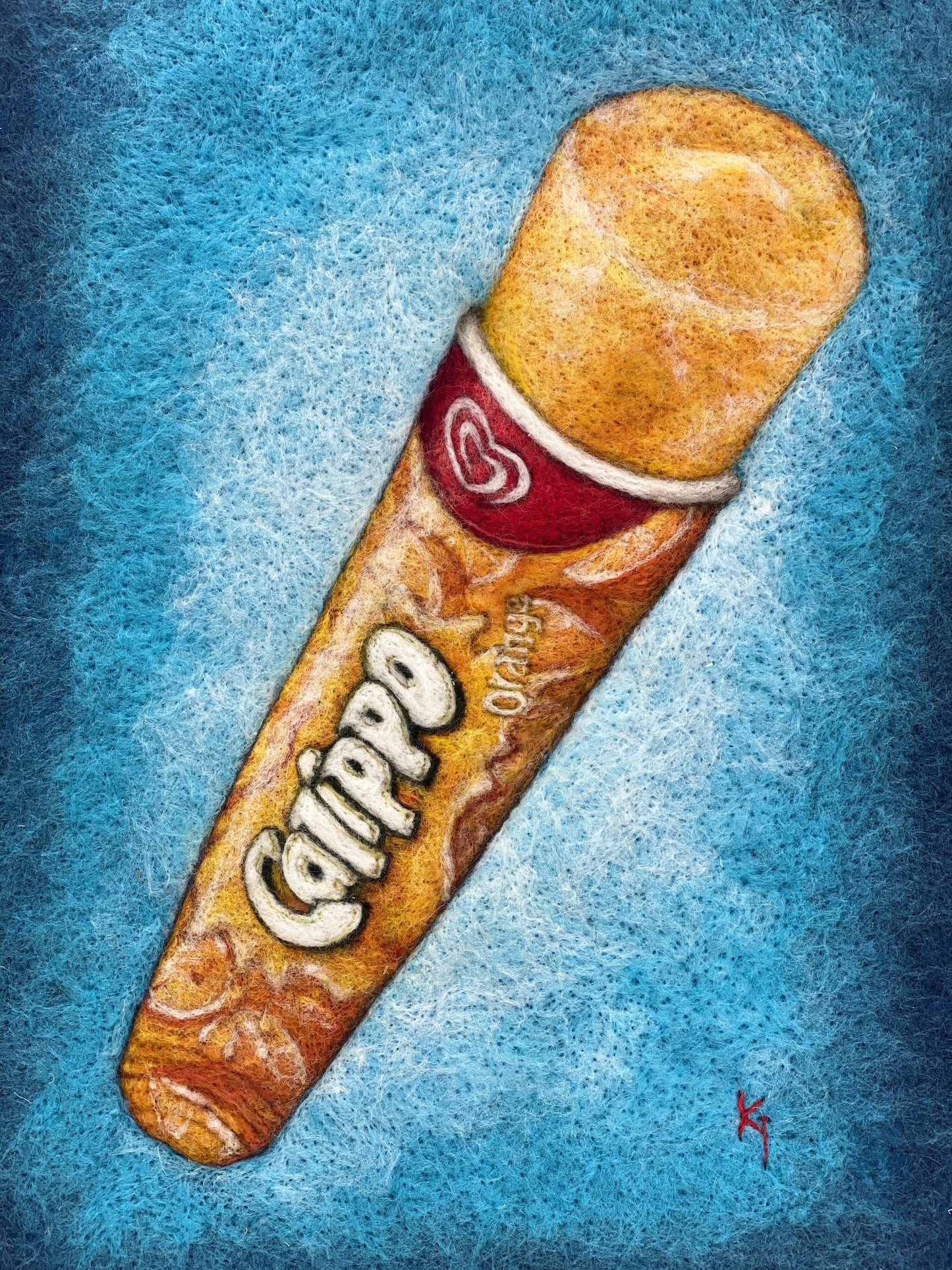 a white box framed needle felted study of an orange flavoured Calippo ice lolly on a blue background