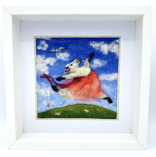 a needle felted image of a sheep in a red tutu, leaping over the grass