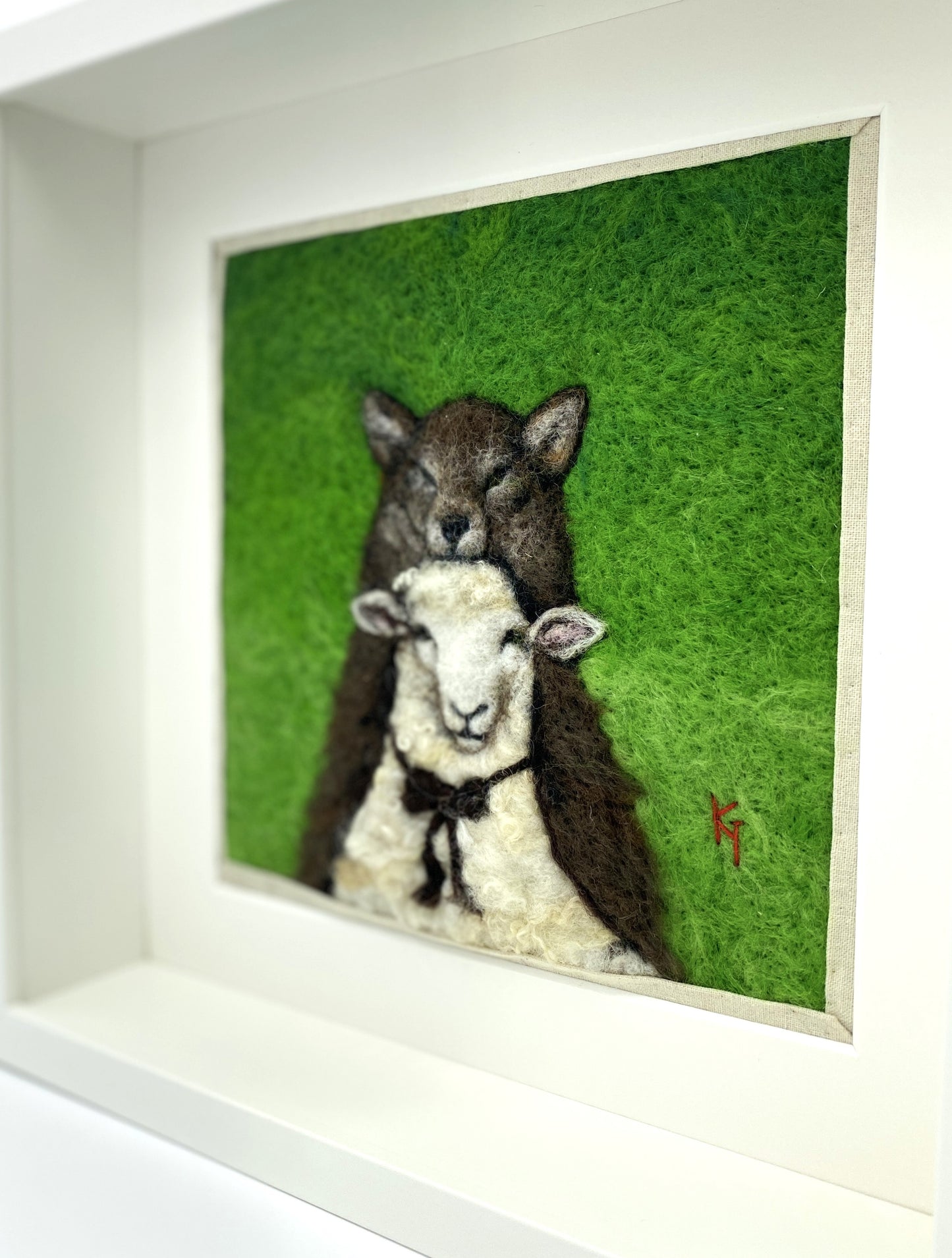 a needle felted portrait of a sheep in a wolf costume with a green background
