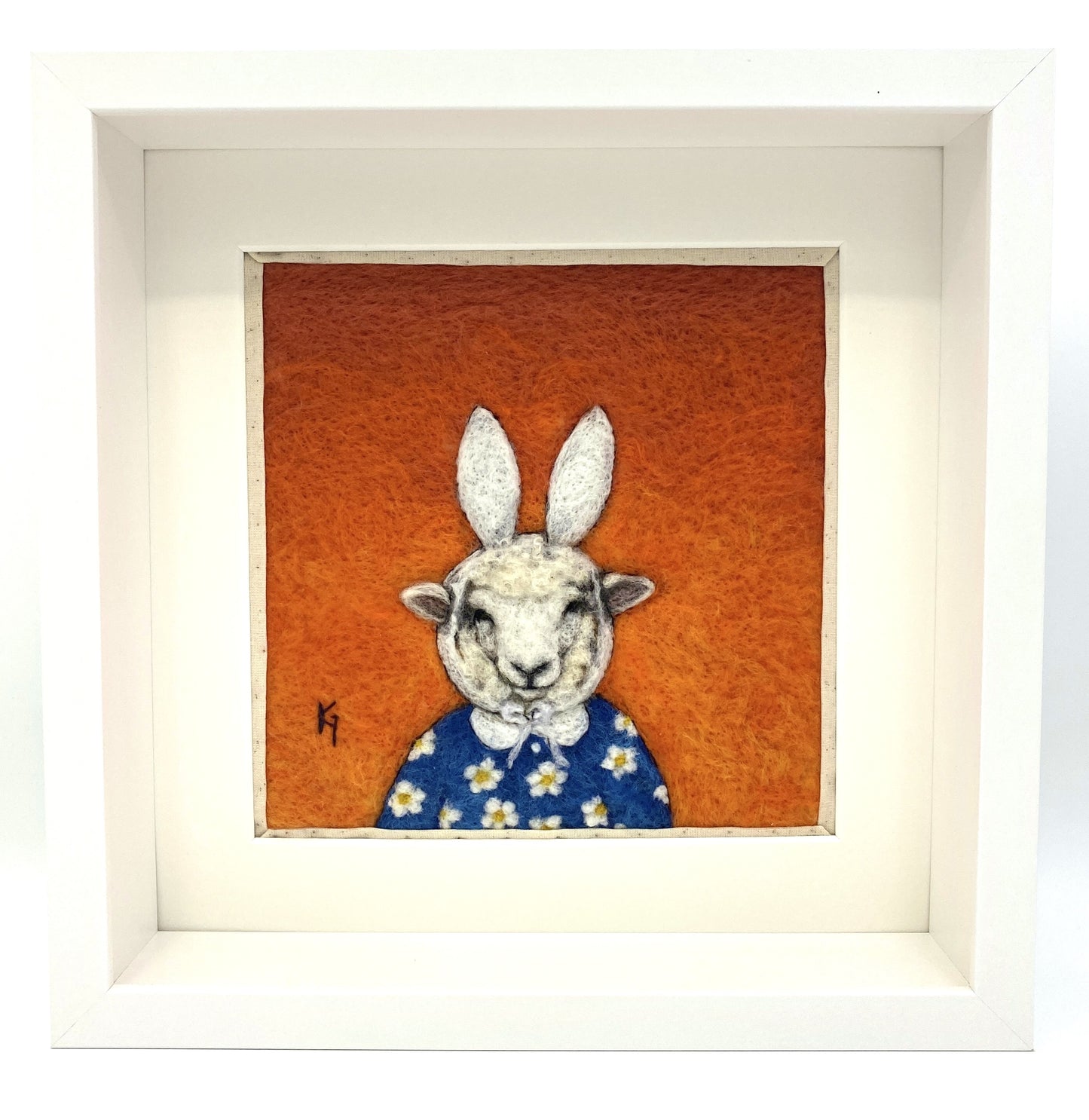 Needle felted picture of a sheep dressed as Miffy in her birthday dress, with an orange background