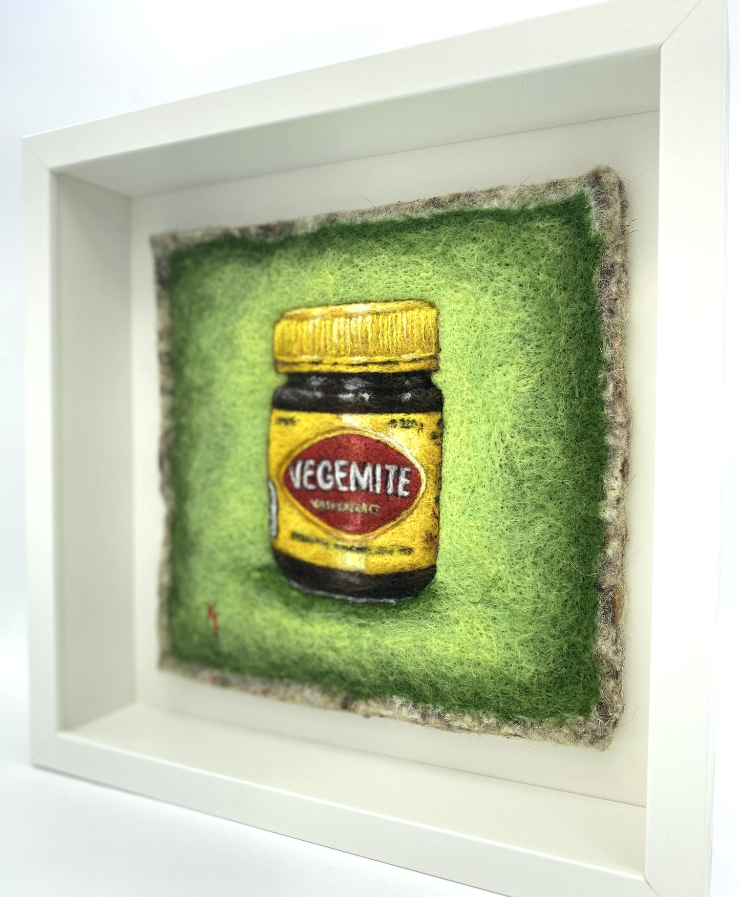 needle felted framed picture of a pot of Vegemite on a green background