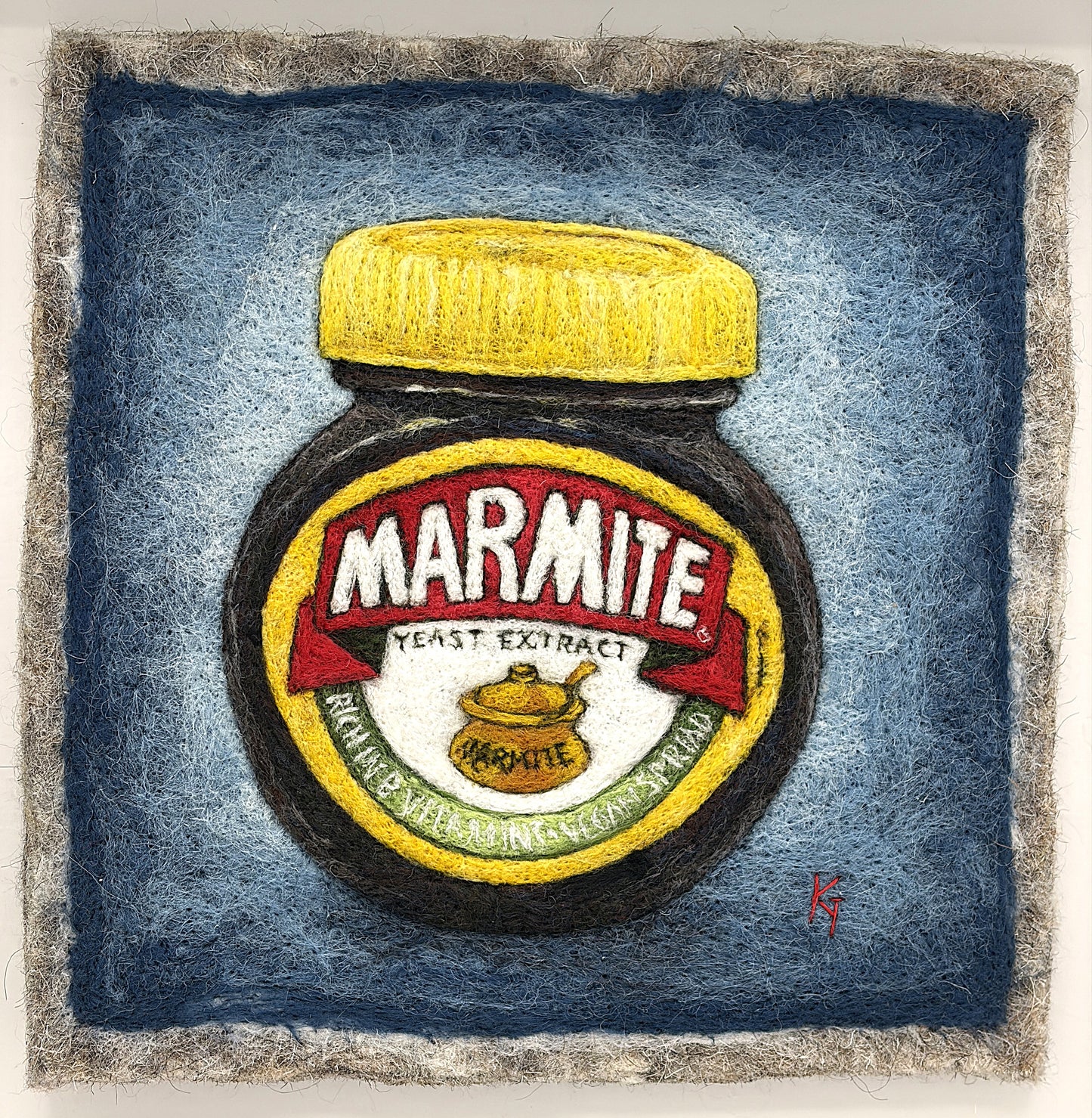 Needle felted framed picture of a pot of Marmite on a blue background