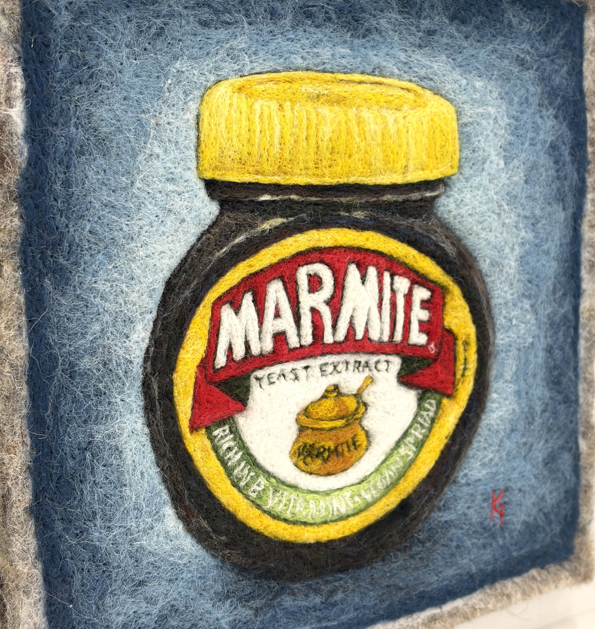 Needle felted framed picture of a pot of Marmite on a blue background