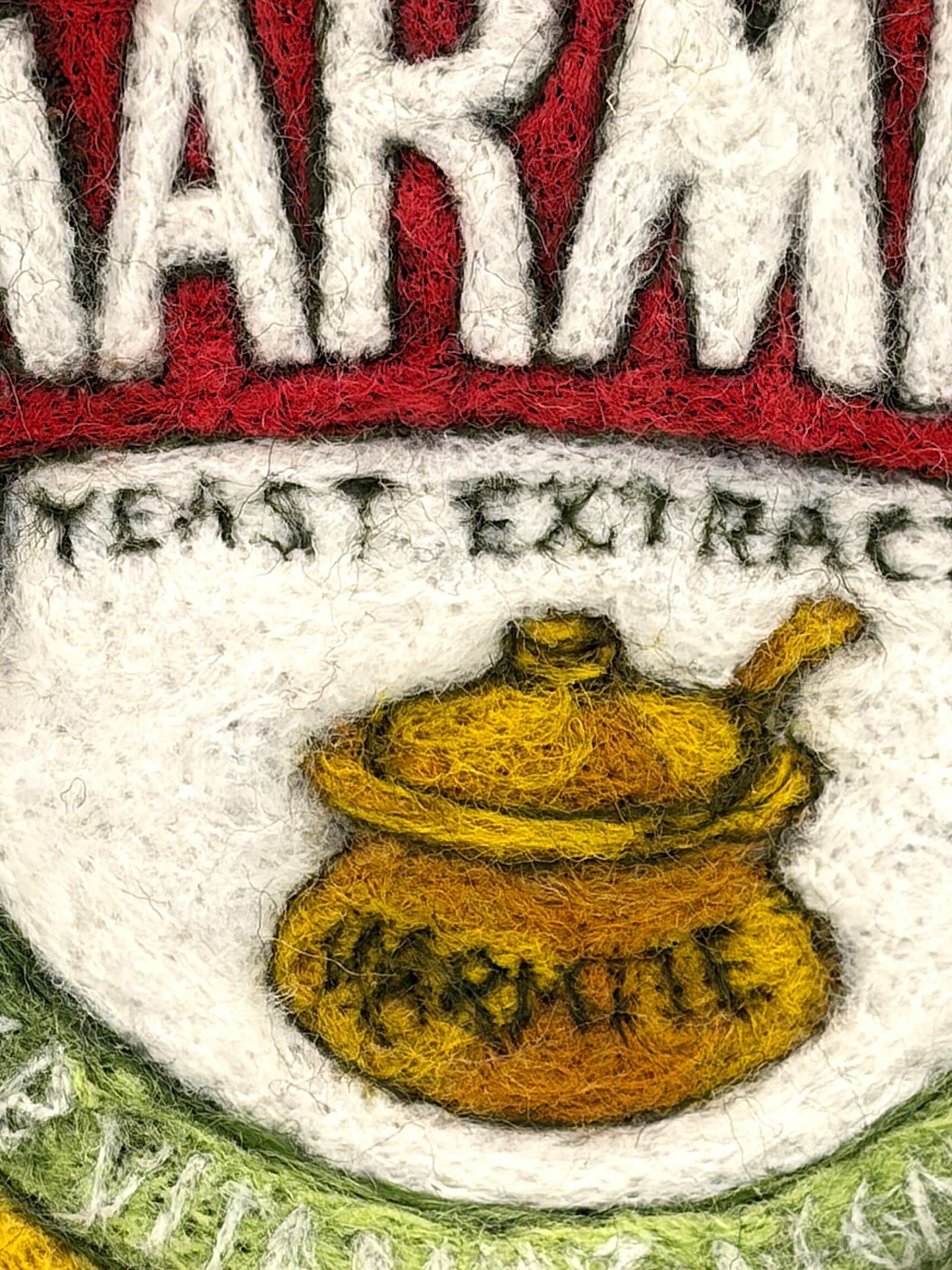 Needle felted framed picture of a pot of Marmite on a blue background