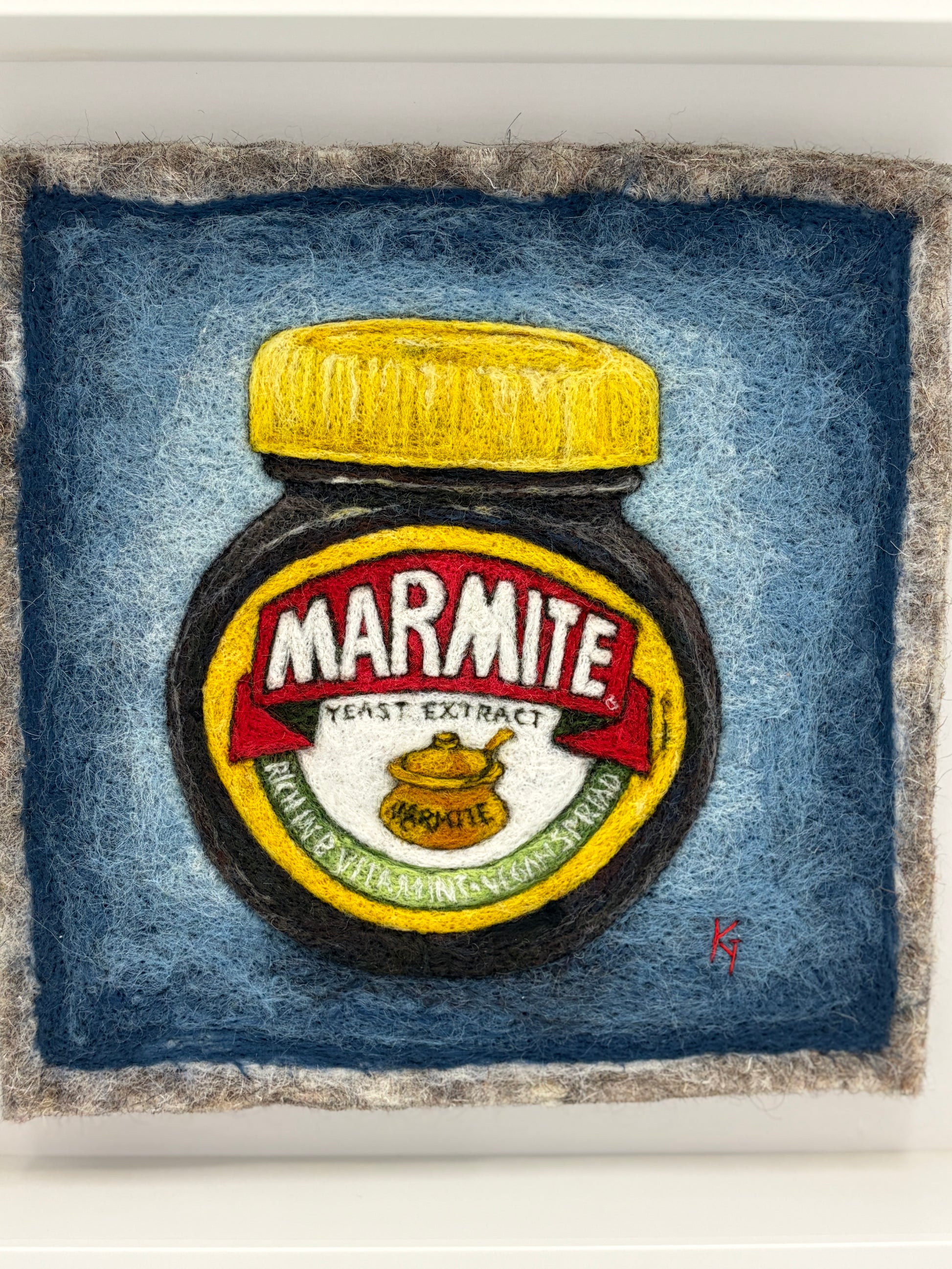Needle felted framed picture of a pot of Marmite on a blue background