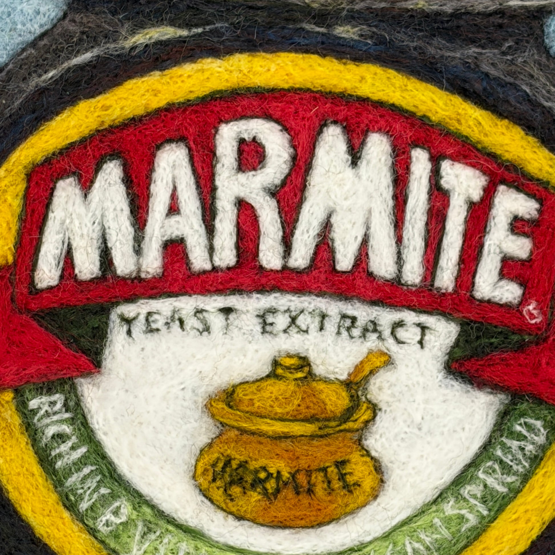 Needle felted framed picture of a pot of Marmite on a blue background
