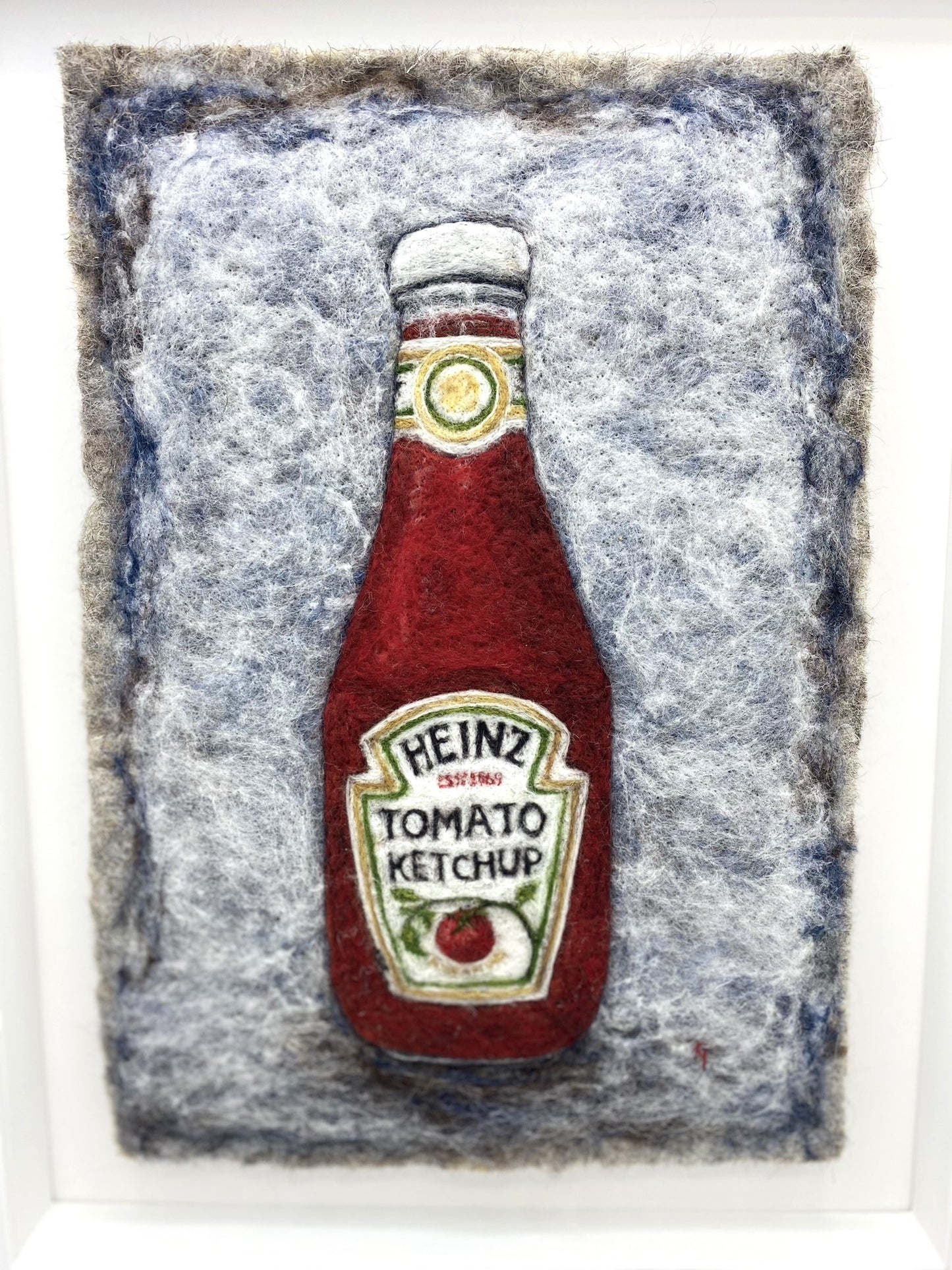 Needle felted study of a glass bottle of Heinz Tomato Ketchup, on blue-grey felted back ground, framed inside a white wooden, glass-fronted box frame white