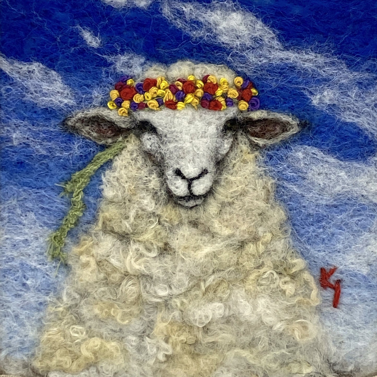 needle felted portrait of a sheep wearing a mulitcoloured stitched crown on a sky blue floral background