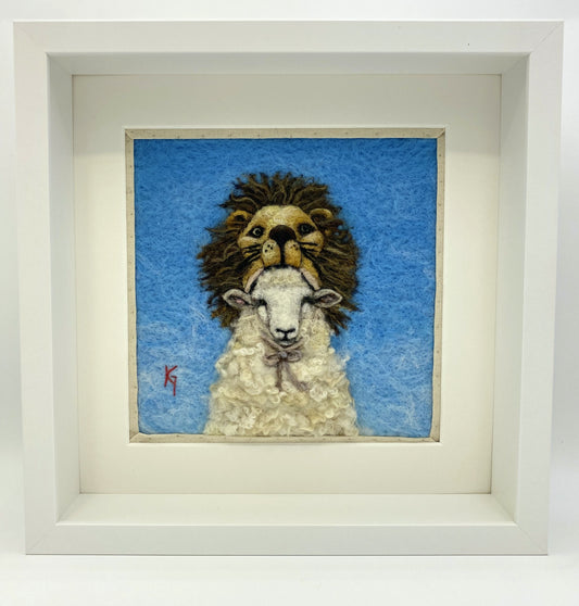 Needle felted framed depiction of a sheep with a lion headdress, with a blue background