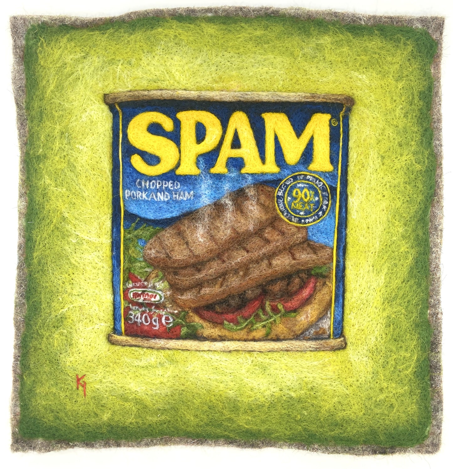 a needle felted picture of a can of Spam on a green background