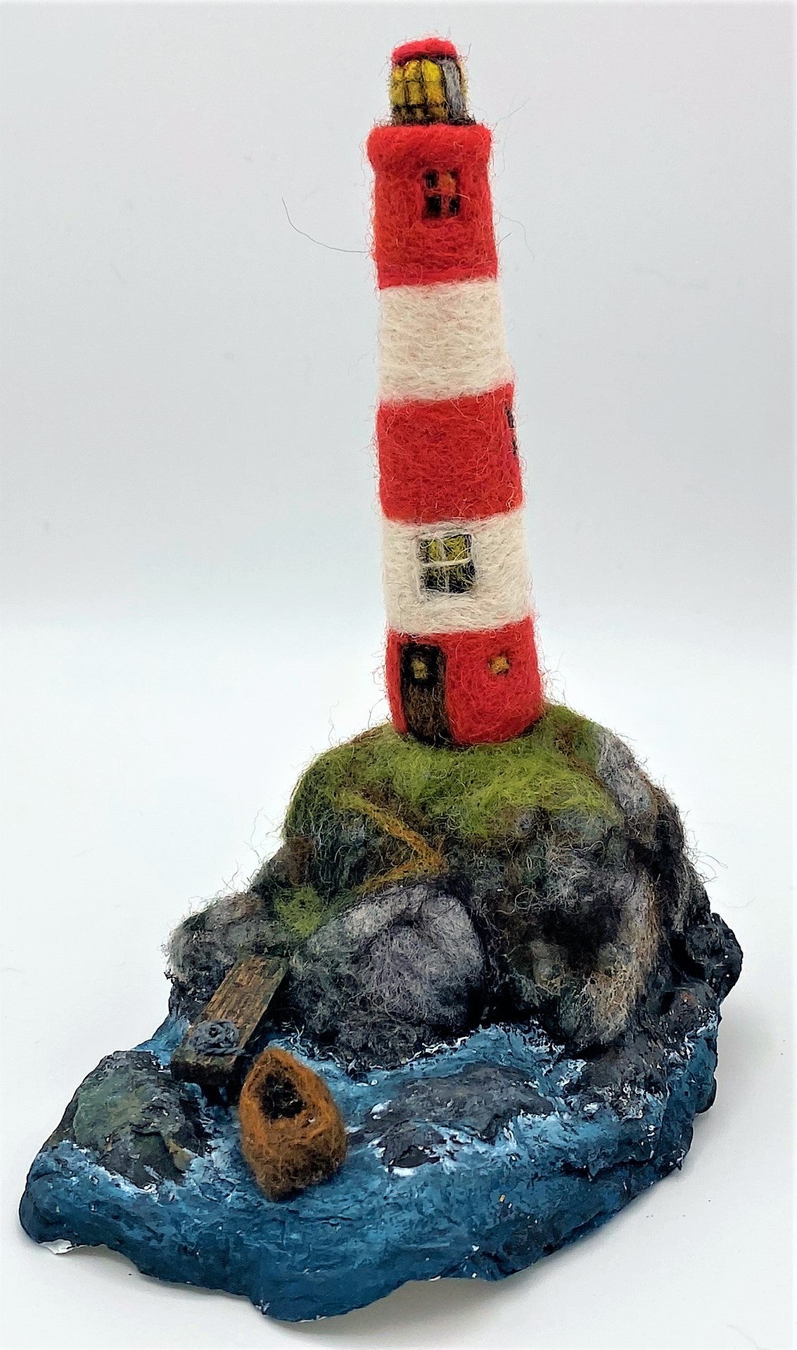 needle felted lighthouse, rocks, boat, jetty, path to front door, sea, grass, painted waves, on oyster shell base 