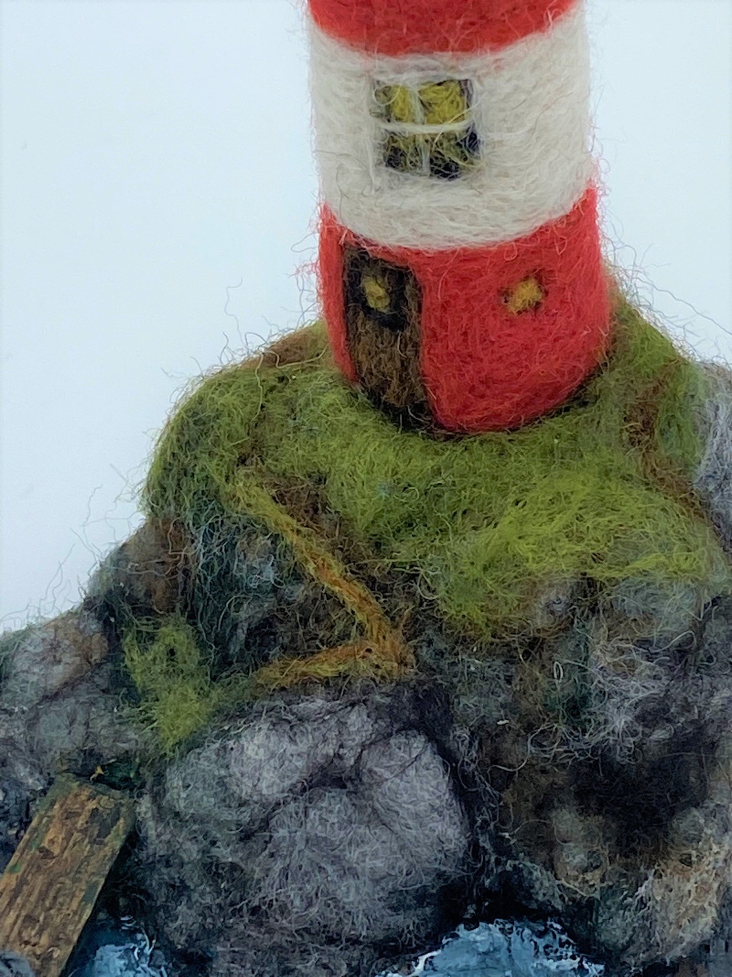 needle felted lighthouse, rocks, boat, jetty, path to front door, sea, grass, painted waves, on oyster shell base 