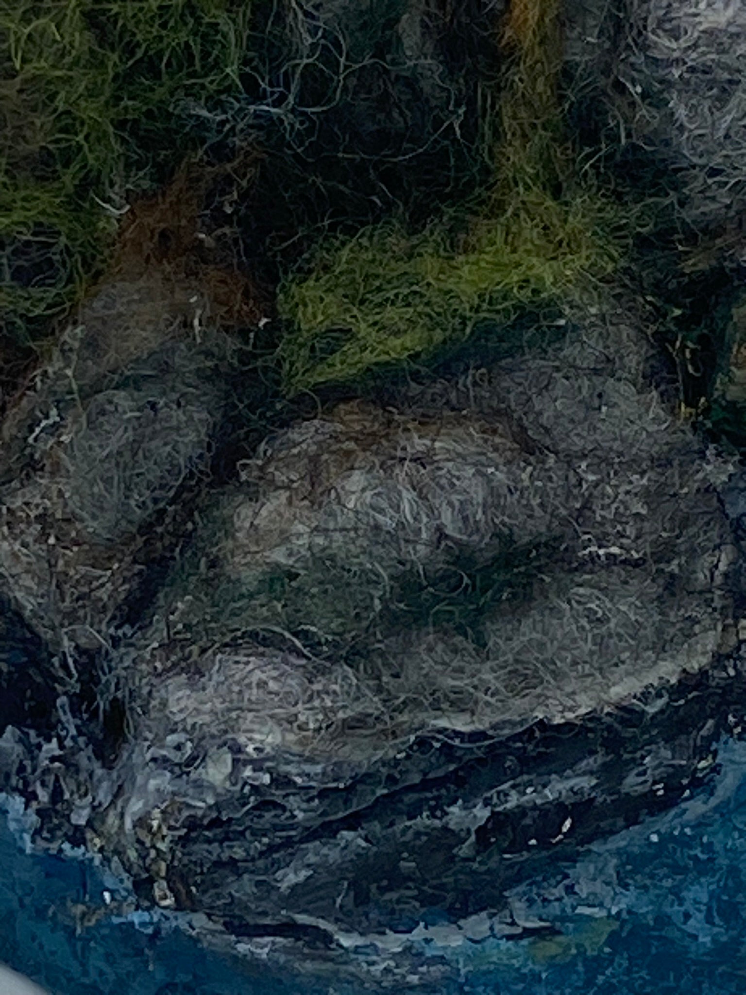 close up of needle felted rocks and grass and painted sea