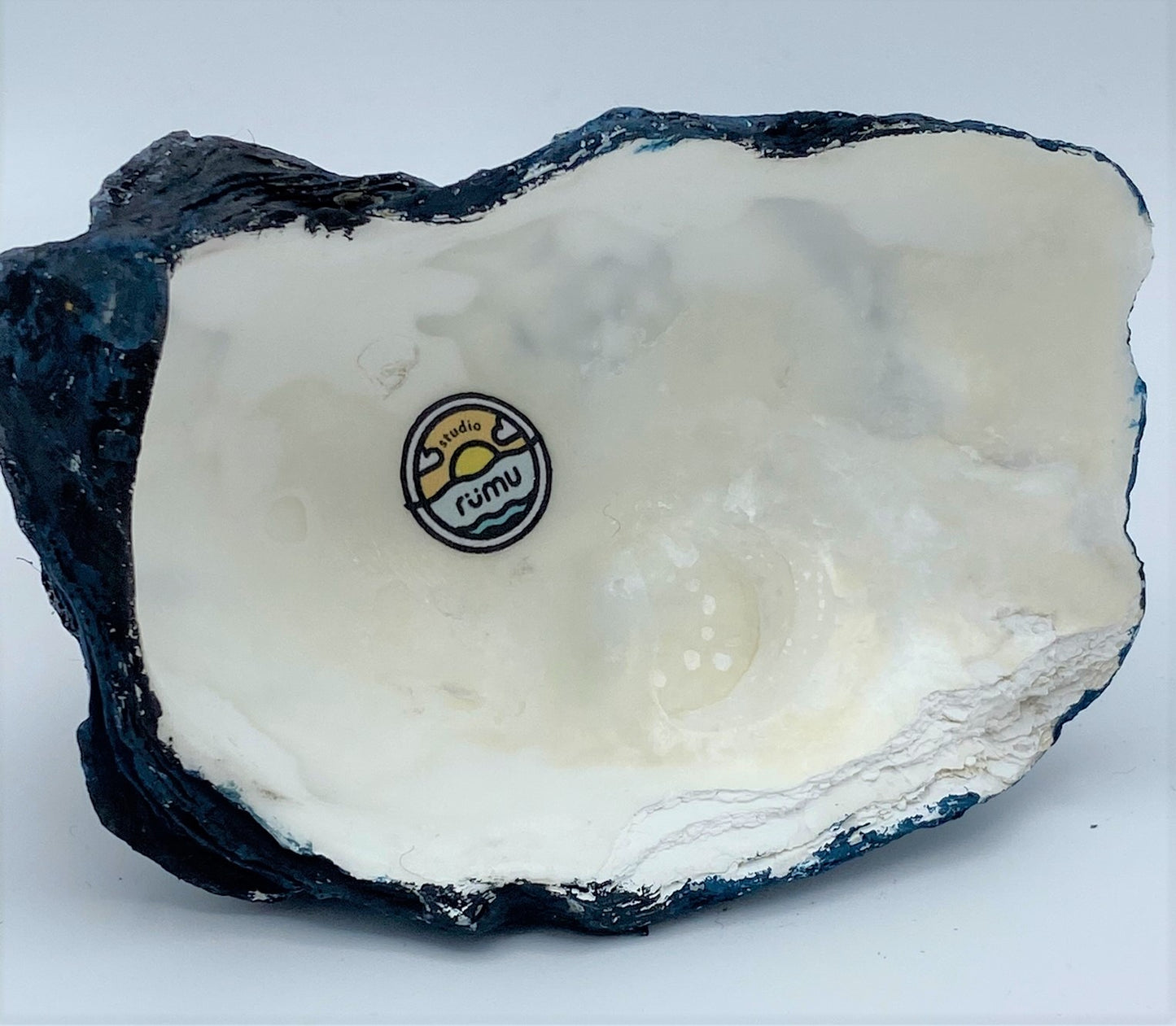 underside of model showing inside of oyster shell, painted edge, studio rumu logo